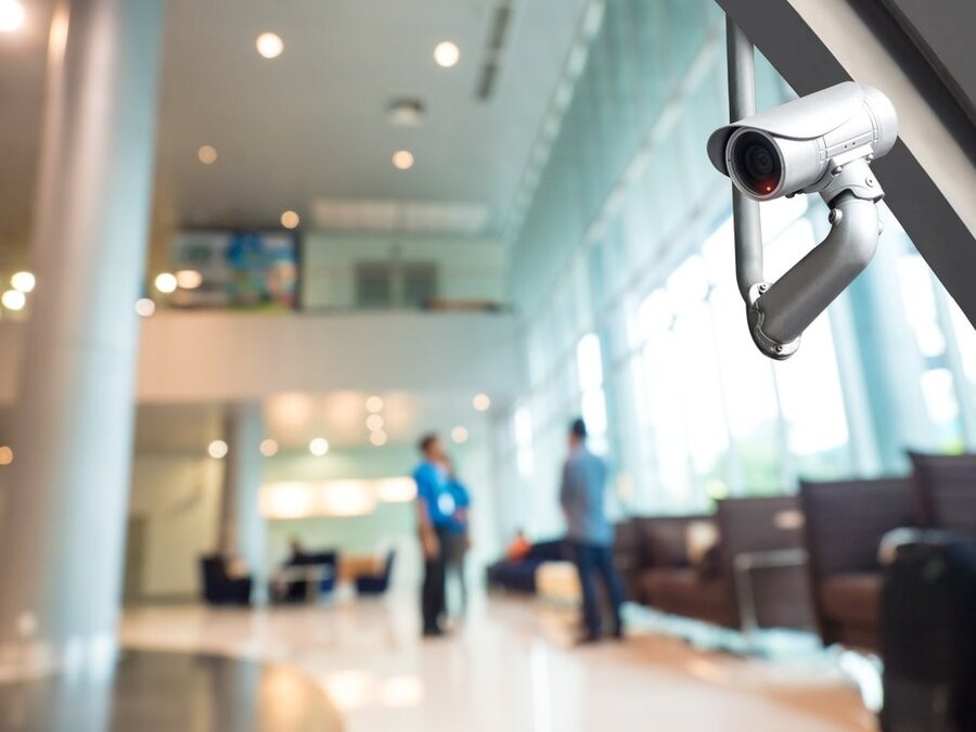 A commercial business lobby with a security camera in view.