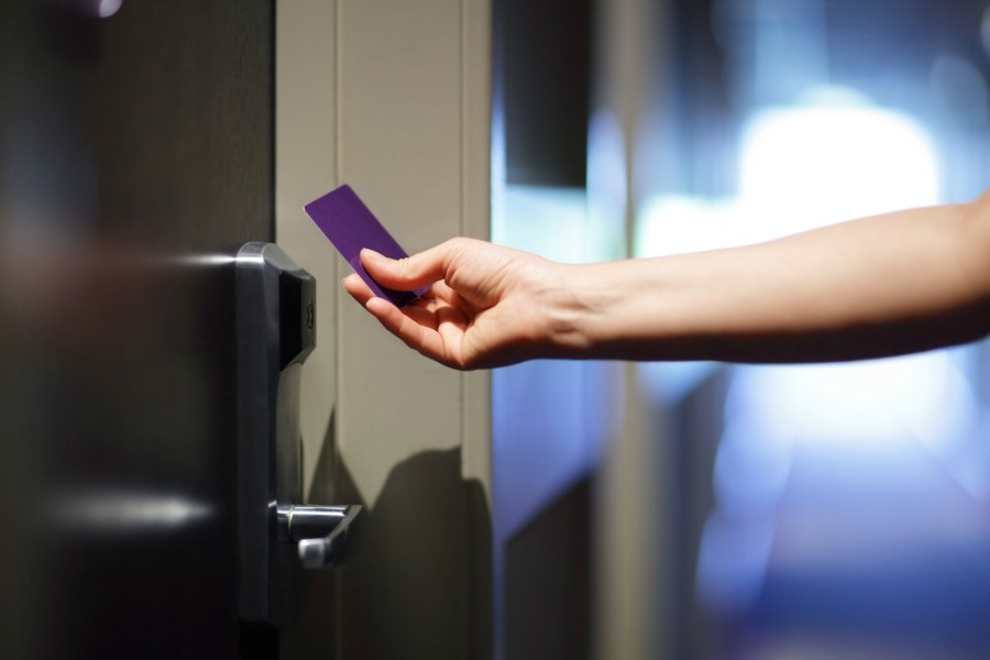 A person using a key card to access their apartment.