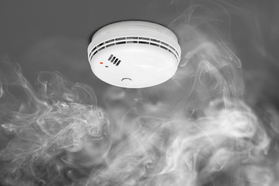 Smoke alarm surrounded by smoke. 