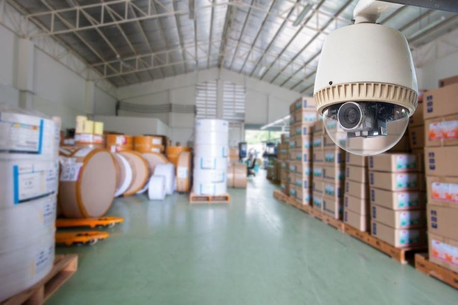 A video surveillance camera in a warehouse.