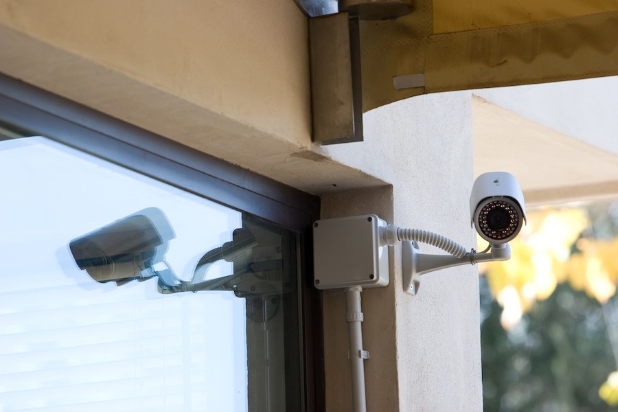 A video surveillance camera watching over a home.