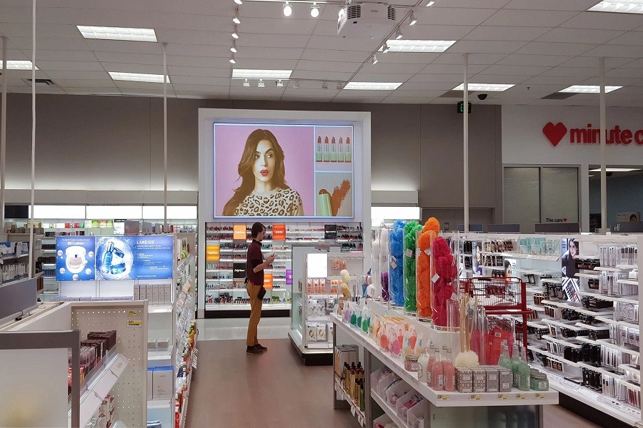 A brightly lit retail environment with a customer shopping under the watch of surveillance cameras. 