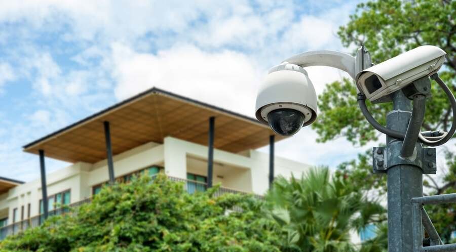 A surveillance camera overlooking a luxury home.