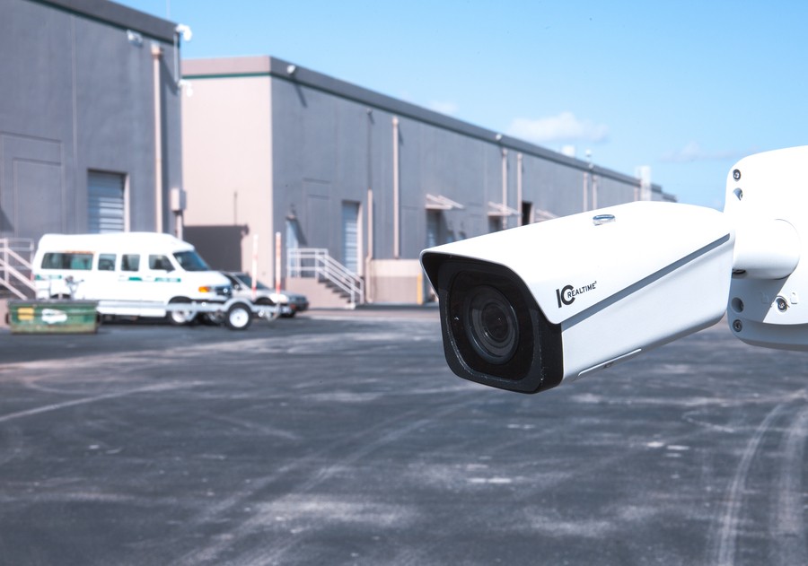 A close-up picture of a commercial security camera surveilling the parking area behind a company warehouse in Kansas City. 